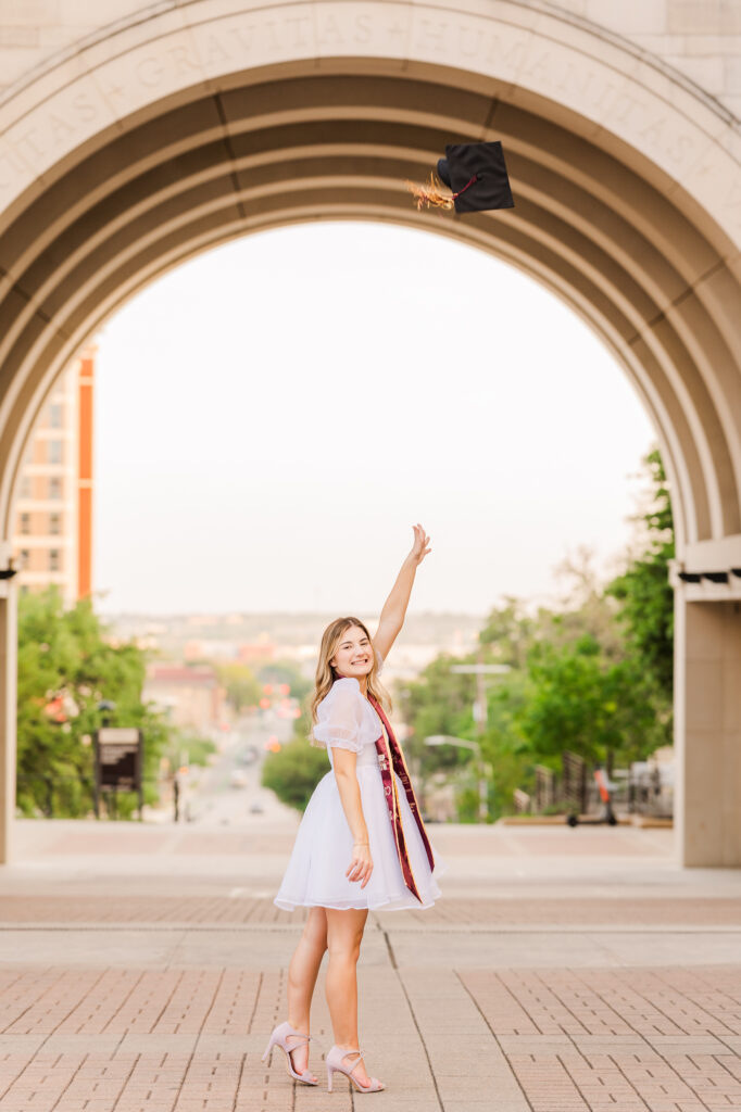 Texas State University senior doing cap toss at the Arch. 