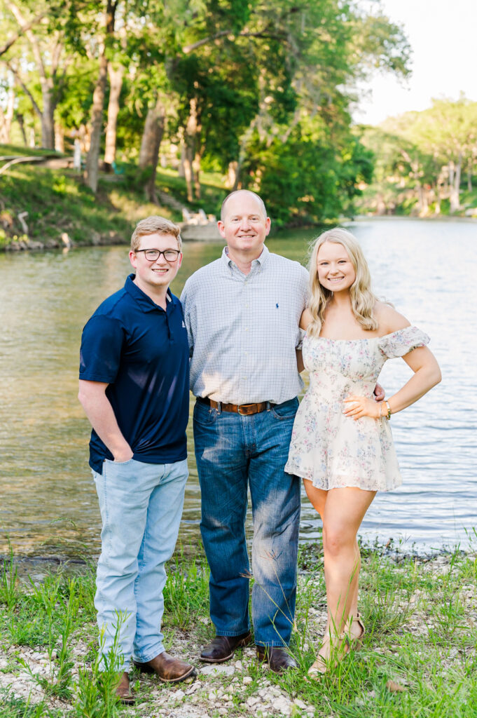 Dad and kids in front of river property in New Braunfels, TX 