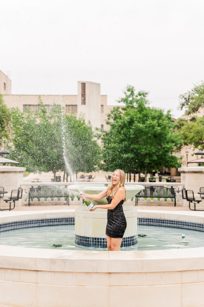 Texas State senior champagne pop in the fountain