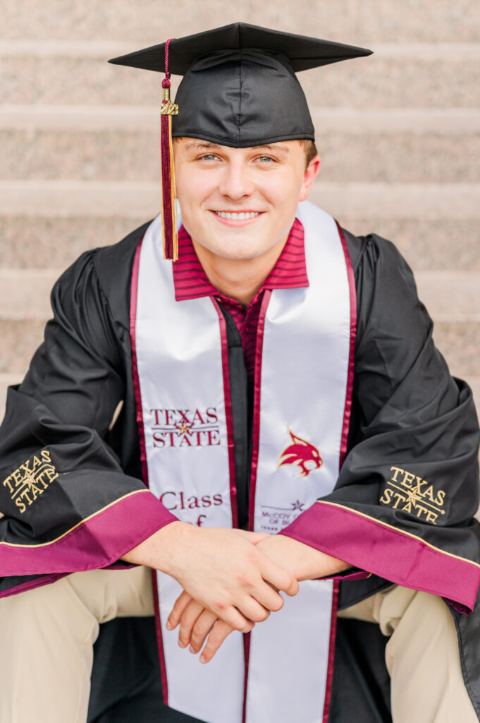 Sitting at Alkek steps for his Texas State University Portraits
