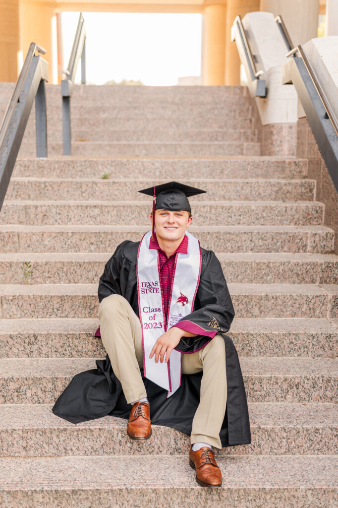 Sitting at Alkek steps for his Texas State University Portraits