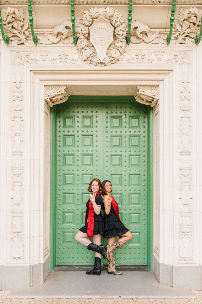 Friends pose in front of green door for their UT Austin graduation session