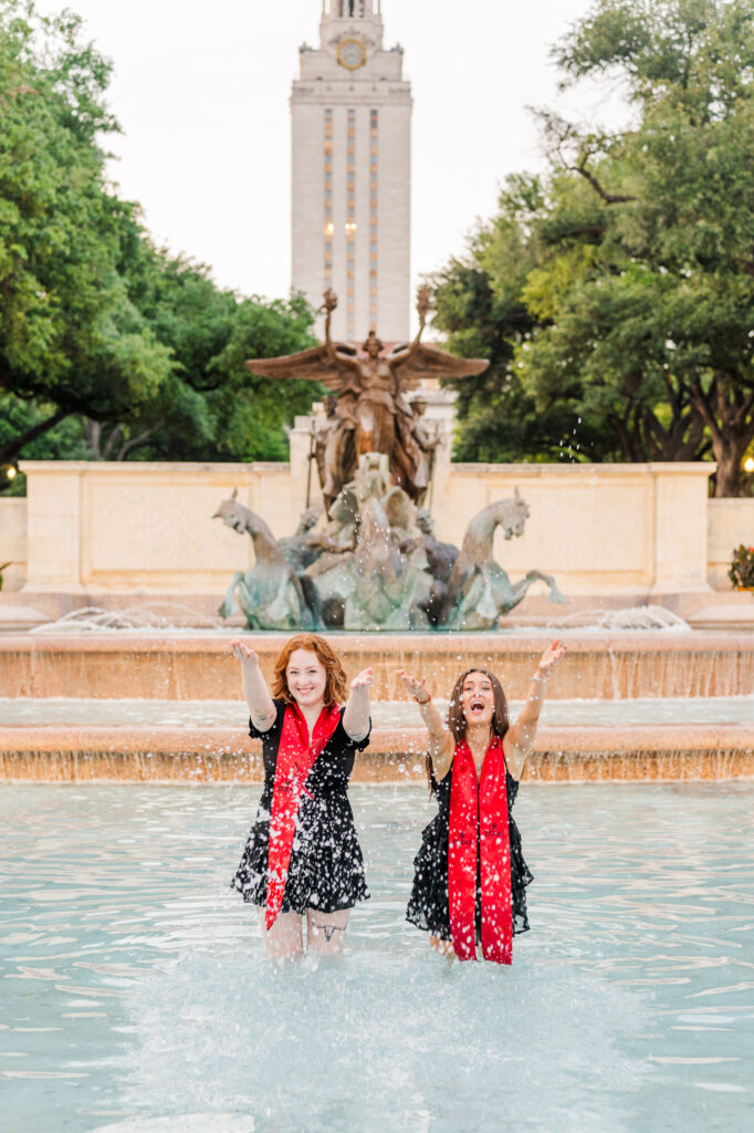 Graduates tossing water in Little Field fountain for their UT Austin Graduation session