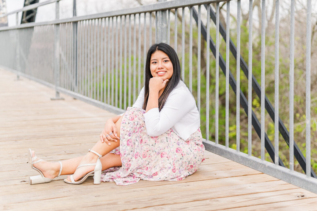 Wimberley High school senior sitting on faust street bridge during their session