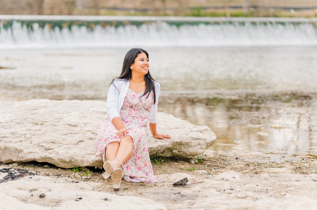 Sitting by the water below Faust Street Bridge during her senior sesssion