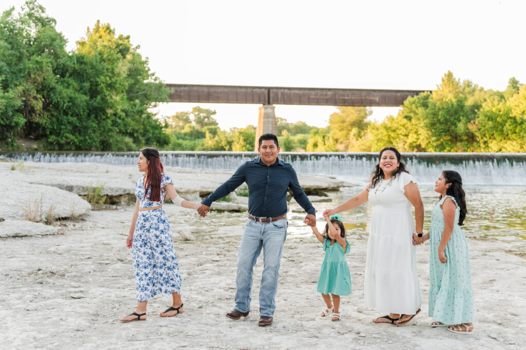 Family Walking down by the water below Faust Street bridge