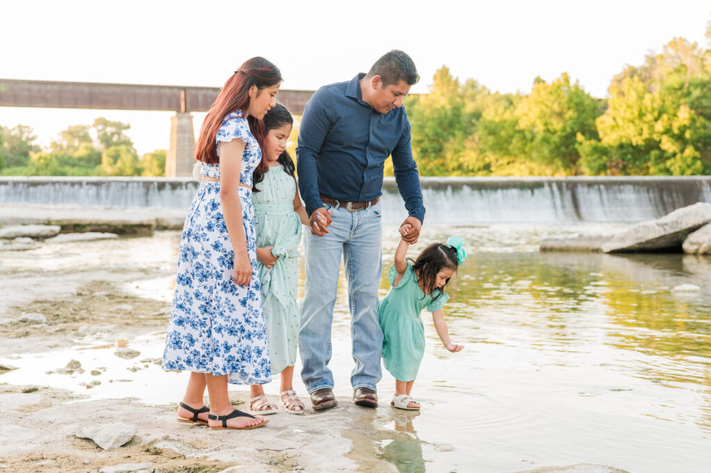 Candid portraits of dad with kids under Faust Street Bridge