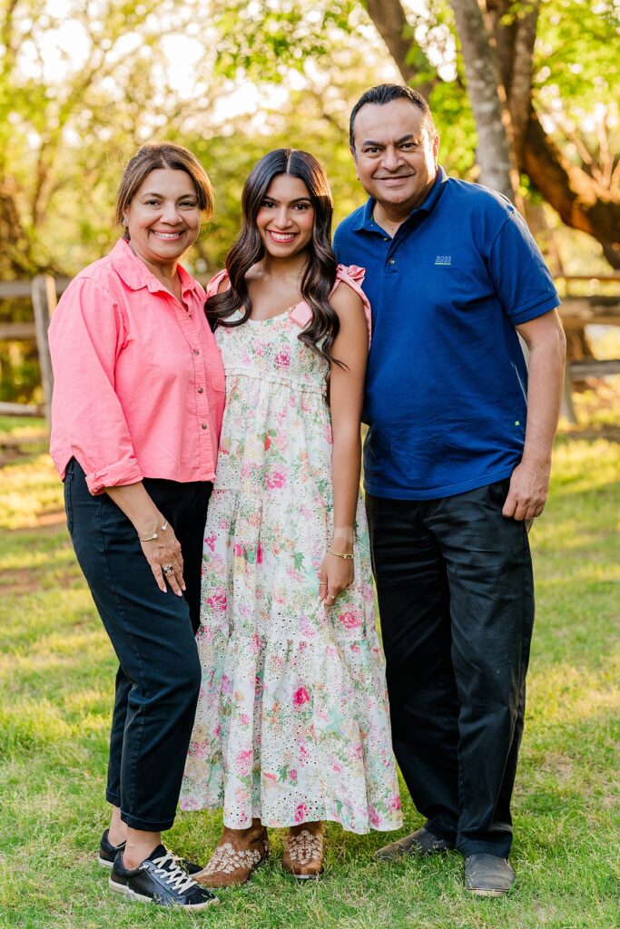 high school senior taking photo with parents